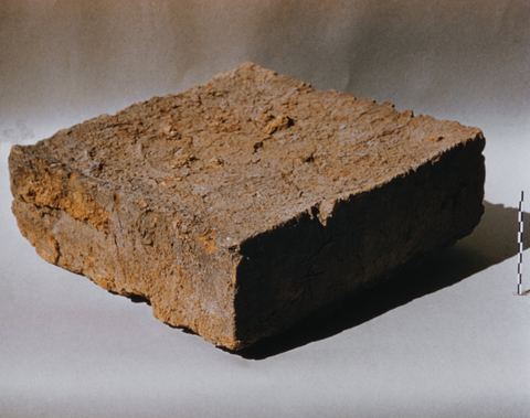 A mud brick from the House of the Tiles at Lerna, photographed as an object.