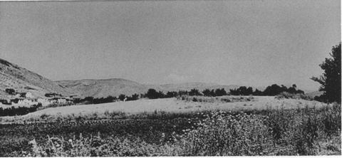 The Lerna mound from the south-east, with houses of Myloi at the foot of Mt Pontinos on the left.