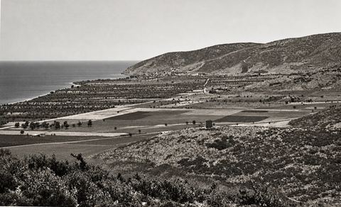 Looking south over the open coastal plain between Myloi and Kiveri, with the road to Tripolis rising on the right and the Vasilopoula tower on a mound.