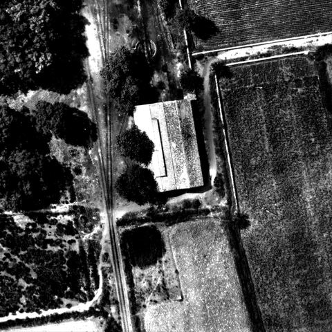 Full-resolution crop of the 1941 aerial photo showing the double locomotive shed: two parallel tiled gabled roofs, one with a long roof lantern, tracks entering from the turntable side.