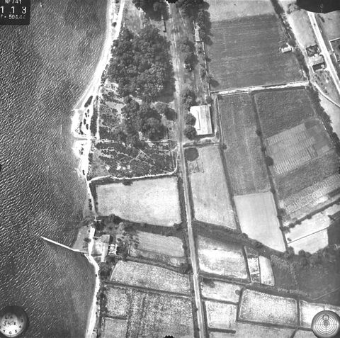 Vertical aerial photo: railway line with eucalyptus wood, a large building beside the track and the pier.
