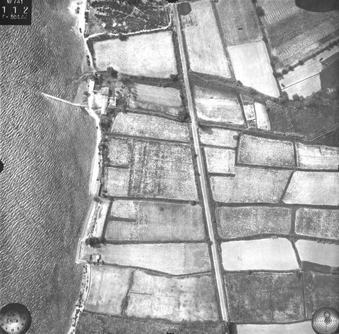 Vertical aerial photo (exposure 112) of the coast at Myloi with the long jetty, fields, road and railway.