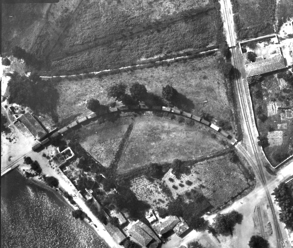 A goods train of about 25 wagons on the curved siding to the pier, with a level crossing and the first village houses, July 1941
