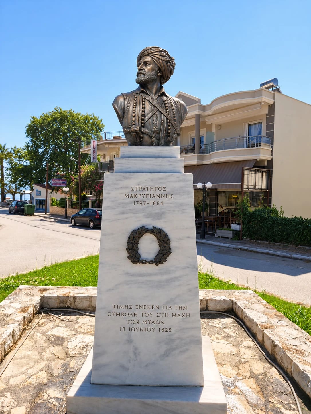 Bronze bust of General Makriyannis in a turban on a white marble pedestal with a laurel wreath and the inscription about the Battle of the Mills, 13 June 1825