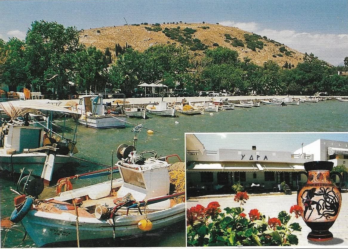 Postcard of the harbour with fishing boats below Pontinos hill, and an inset of restaurant ΥΔΡΑ with flowers and an amphora