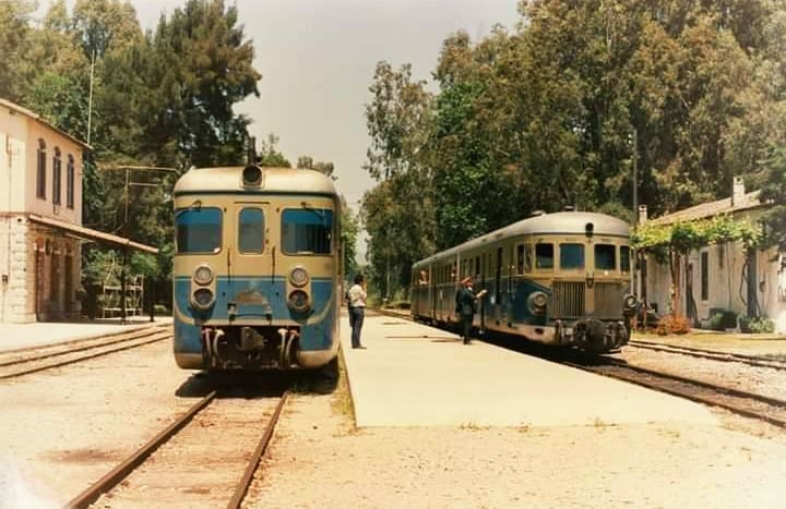 Δύο αυτοκινητάμαξες στους Μύλους, με το πέτρινο κτήριο του σταθμού αριστερά
