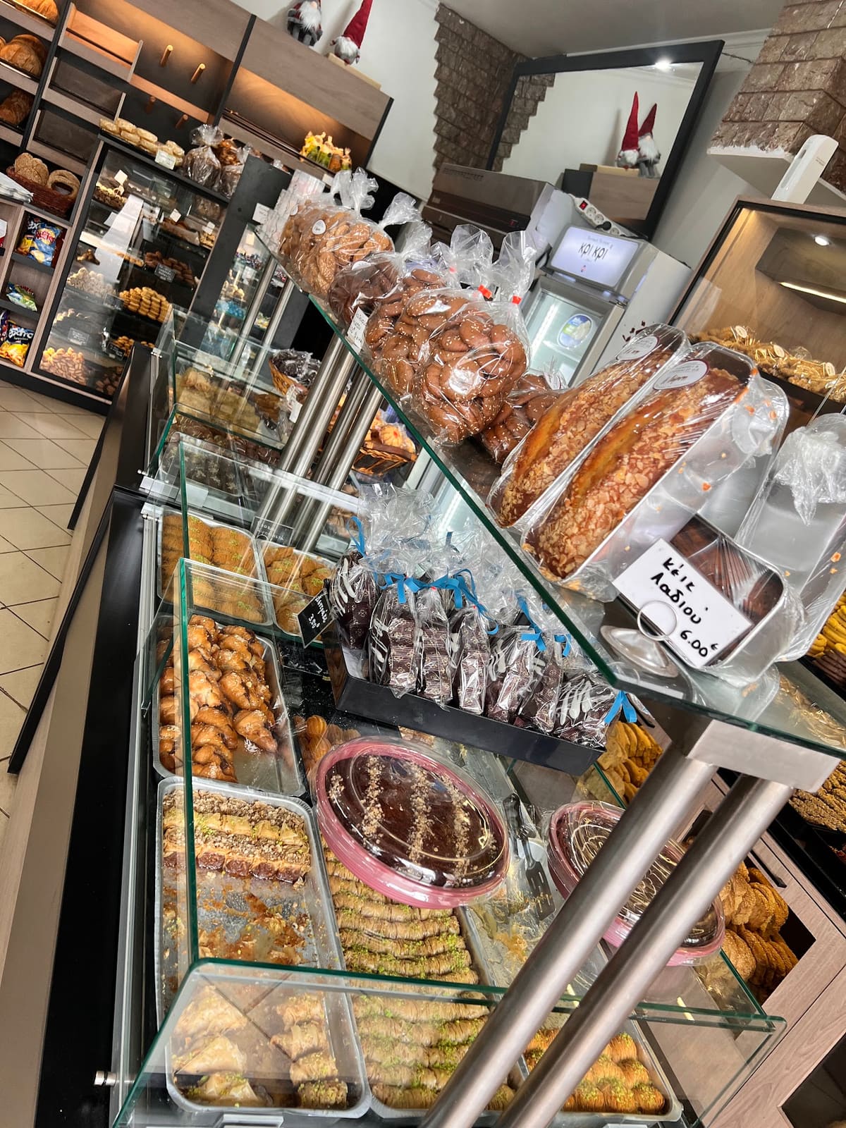 Glass display cases full of pies, koulouria, biscuits and Greek sweets