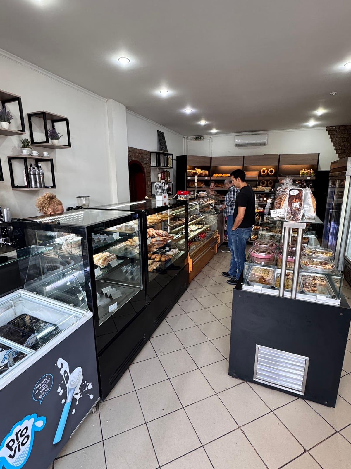 Inside the bakery: a long, bright shop with display counters on both sides