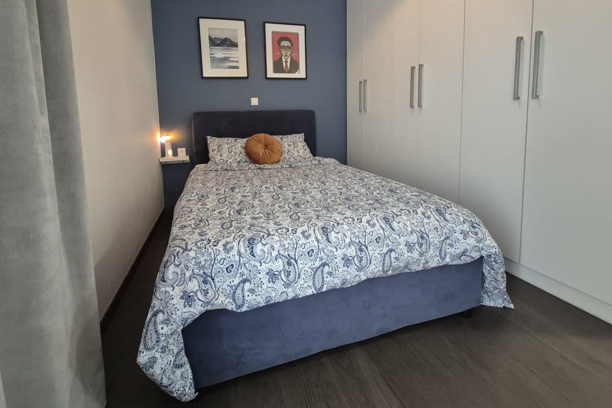 Bedroom with a double bed and a large wardrobe