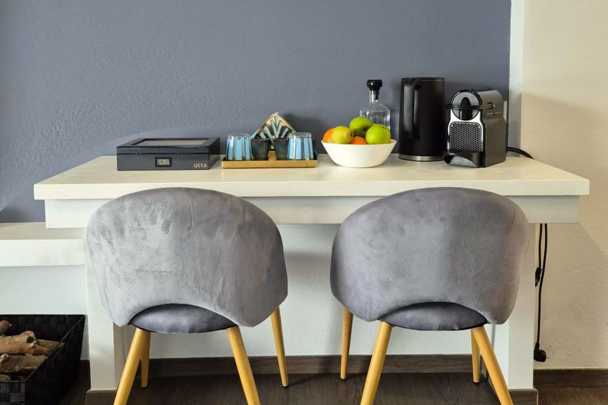 Breakfast bar with two chairs, coffee machine and kettle