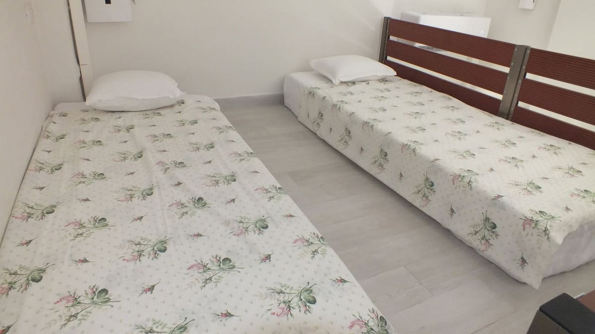 Two single beds with floral bedspreads